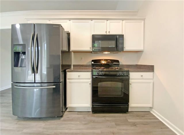 2012 Elm Grove Ln, Hampton, GA 30228 - kitchen featuring baseboards, white cabinetry, black appliances, and dark countertops