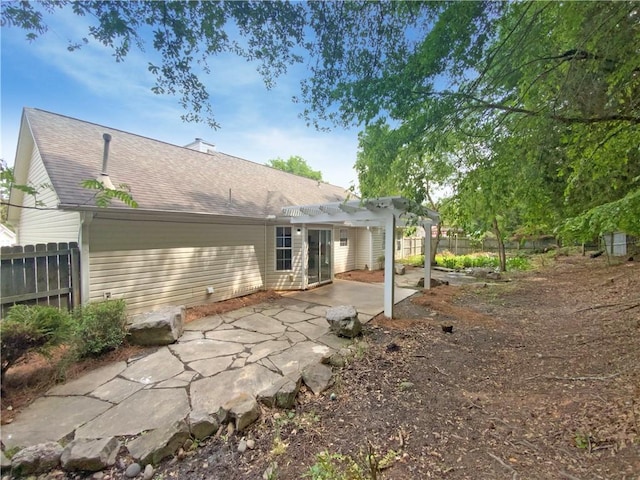2012 Elm Grove Ln, Hampton, GA 30228 - rear view of house featuring fence, a pergola, a shingled roof, and a patio area