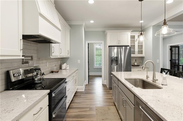kitchen with appliances with stainless steel finishes, custom range hood, a sink, glass insert cabinets, and white cabinetry