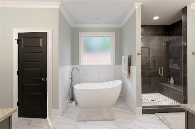 full bathroom with marble look tiles, a shower stall, a soaking tub, crown molding, and wainscoting