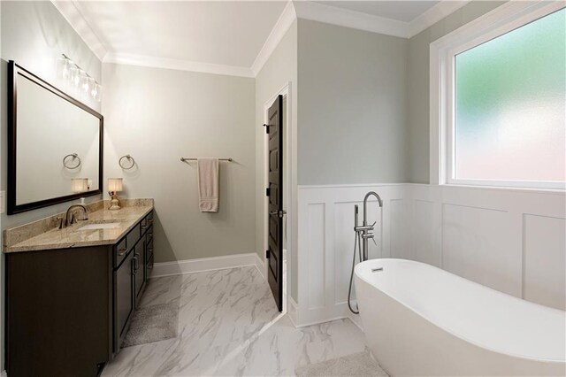 full bath with vanity, a freestanding tub, marble finish flooring, a wainscoted wall, and crown molding