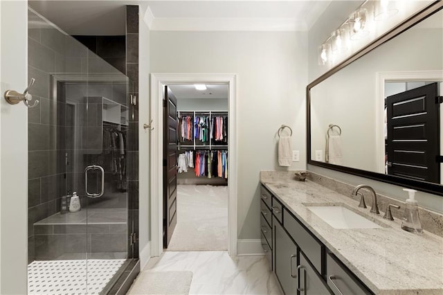 full bath featuring vanity, a stall shower, crown molding, marble finish flooring, and baseboards