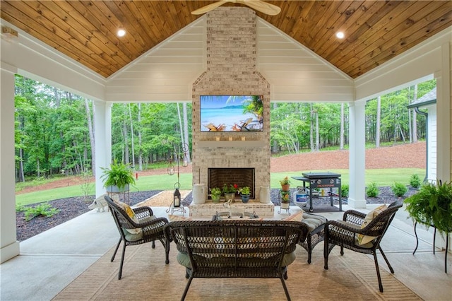 view of patio with an outdoor living space with a fireplace