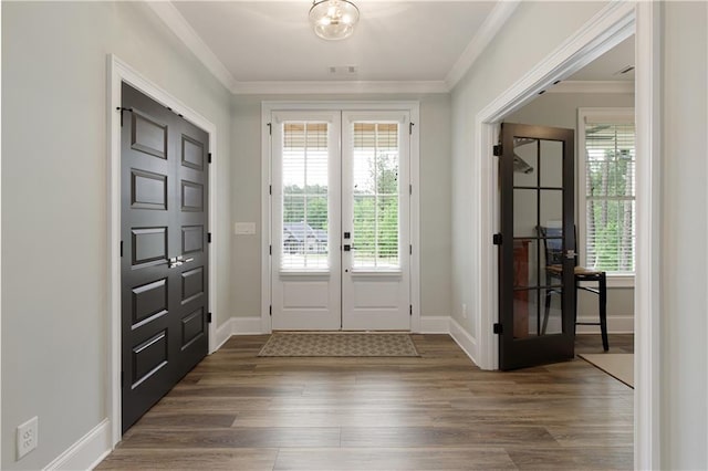 doorway featuring dark wood-style flooring, french doors, ornamental molding, and baseboards