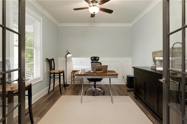 home office featuring crown molding, dark wood-style flooring, a ceiling fan, and wainscoting