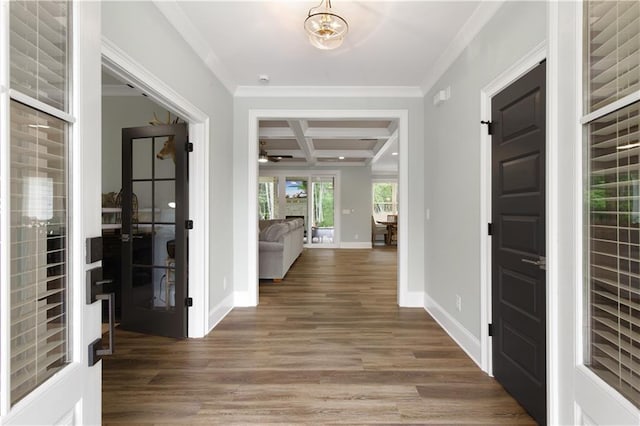 foyer entrance featuring coffered ceiling, ornamental molding, french doors, wood finished floors, and beamed ceiling