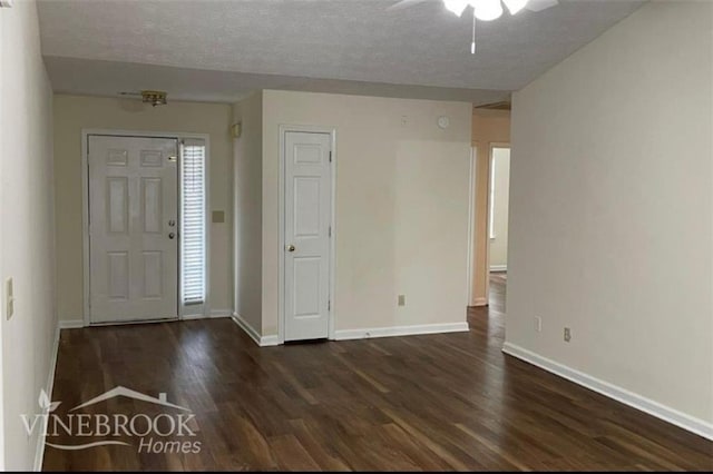 504 Edgewood Trce, Mcdonough, GA 30253 - entrance foyer featuring dark wood finished floors, ceiling fan, and a textured ceiling