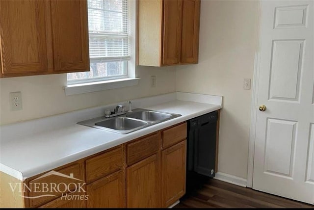504 Edgewood Trce, Mcdonough, GA 30253 - kitchen with black dishwasher, brown cabinetry, light countertops, and dark wood-style flooring