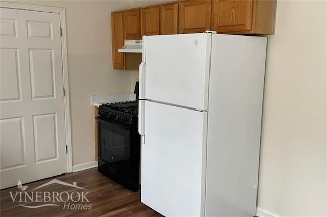 504 Edgewood Trce, Mcdonough, GA 30253 - kitchen with freestanding refrigerator, black range with gas stovetop, dark wood finished floors, under cabinet range hood, and light countertops