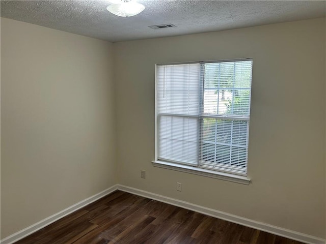 504 Edgewood Trce, Mcdonough, GA 30253 - spare room with dark wood-style floors and a textured ceiling