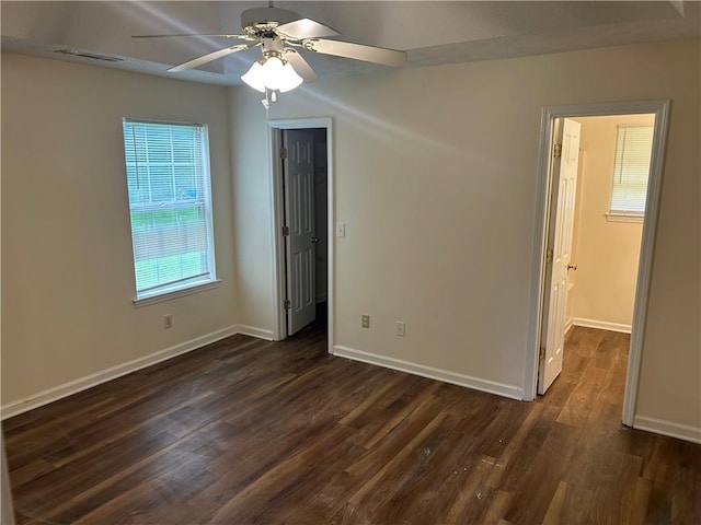 504 Edgewood Trce, Mcdonough, GA 30253 - unfurnished bedroom with a spacious closet, dark wood-type flooring, a closet, and ceiling fan