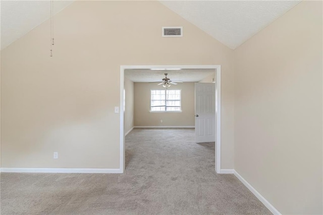 spare room with visible vents, baseboards, light colored carpet, and a ceiling fan