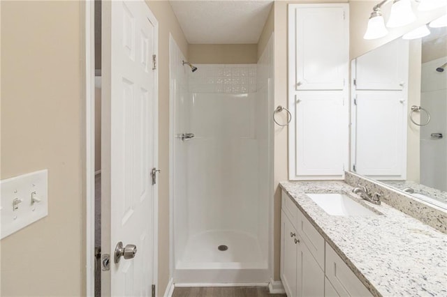 bathroom featuring vanity and a shower stall