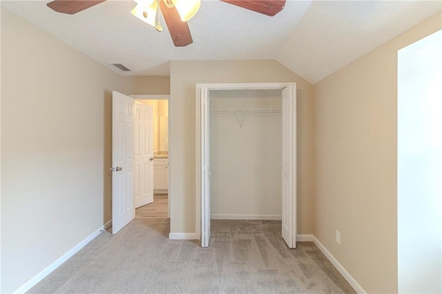 unfurnished bedroom featuring baseboards, visible vents, a closet, and light carpet