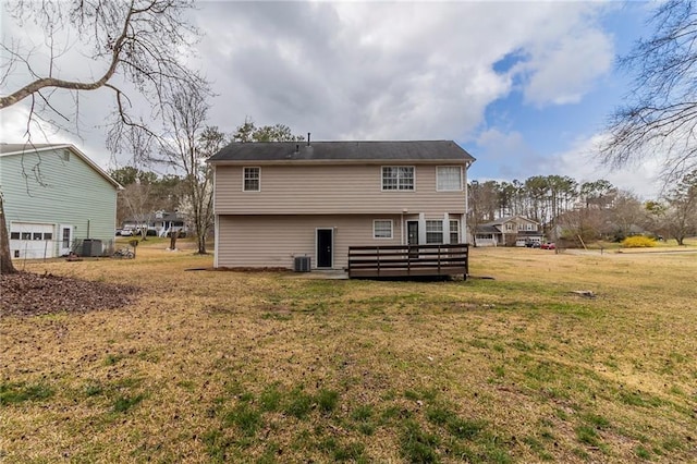 back of house with central AC unit, a lawn, and a wooden deck