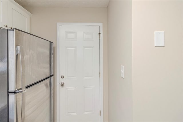 doorway with a textured ceiling