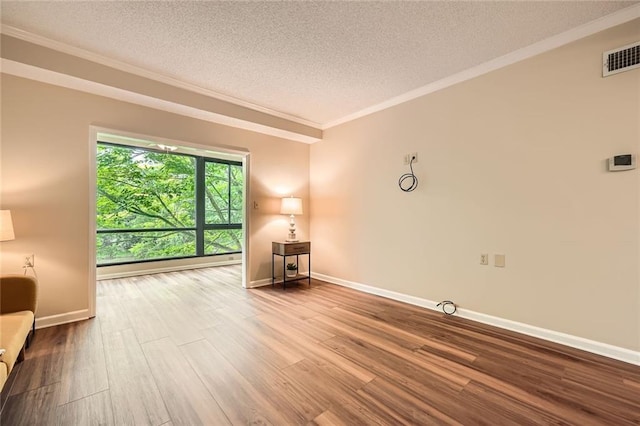 1800 Clairmont Lk Unit A310, Decatur, GA 30033 - unfurnished room with a textured ceiling, crown molding, wood finished floors, and baseboard heating
