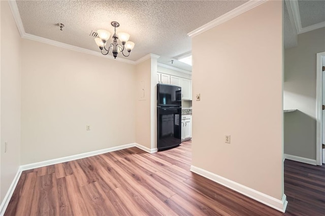 1800 Clairmont Lk Unit A310, Decatur, GA 30033 - unfurnished dining area featuring wood finished floors, a chandelier, a textured ceiling, and crown molding