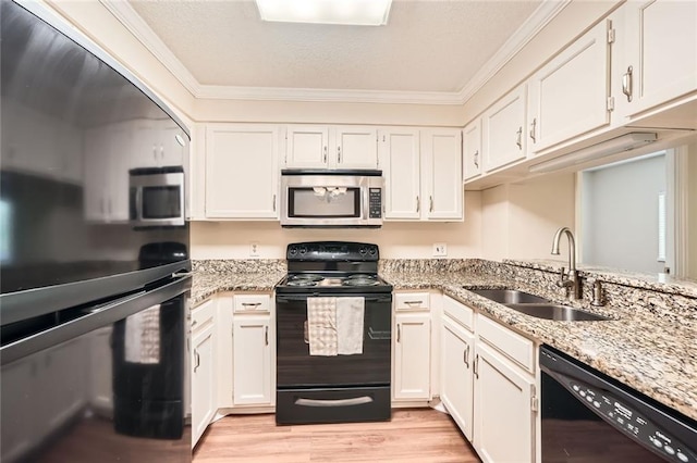 1800 Clairmont Lk Unit A310, Decatur, GA 30033 - kitchen featuring black appliances, crown molding, light wood-type flooring, light stone countertops, and white cabinetry