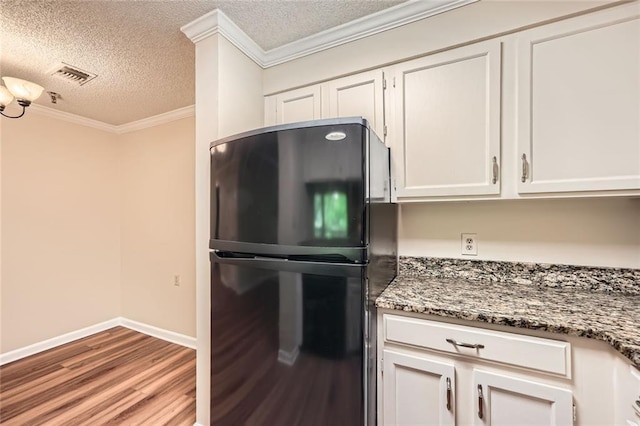 1800 Clairmont Lk Unit A310, Decatur, GA 30033 - kitchen with freestanding refrigerator, wood finished floors, a textured ceiling, crown molding, and white cabinetry