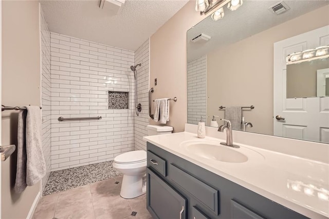 1800 Clairmont Lk Unit A310, Decatur, GA 30033 - full bathroom featuring a tile shower, vanity, a textured ceiling, and tile patterned floors
