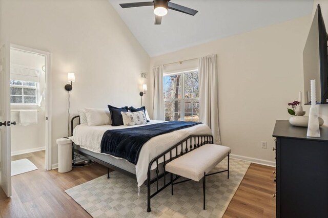 bedroom featuring ceiling fan, wood-type flooring, and high vaulted ceiling