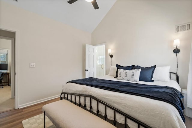 bedroom with hardwood / wood-style floors, high vaulted ceiling, and ceiling fan