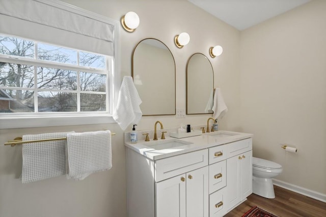 bathroom with wood-type flooring, toilet, and vanity