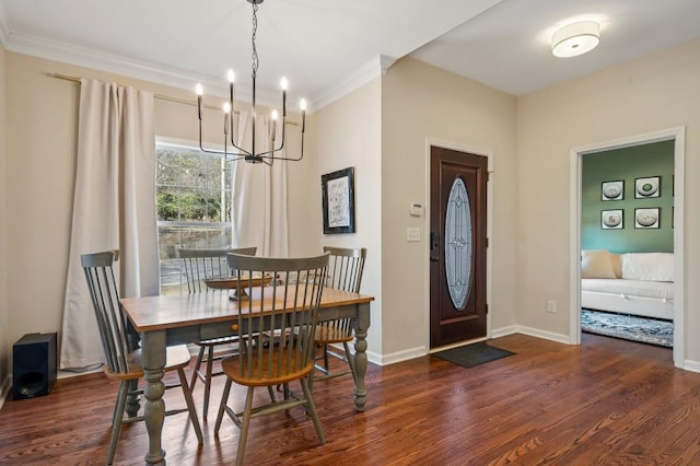 dining space with dark hardwood / wood-style flooring, ornamental molding, and a chandelier