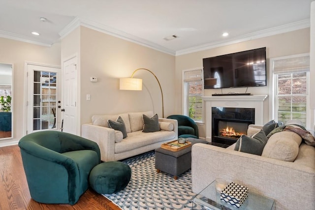 living room with wood-type flooring and ornamental molding