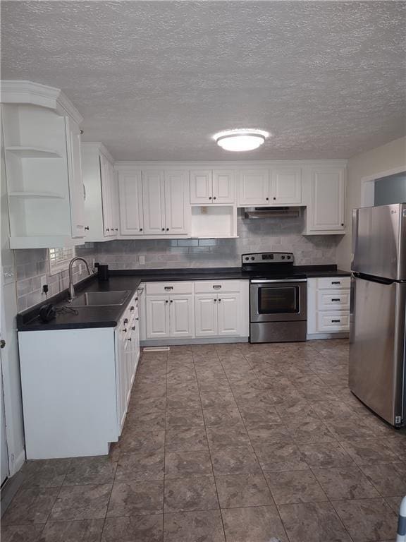 kitchen with stainless steel appliances, white cabinetry, sink, and backsplash