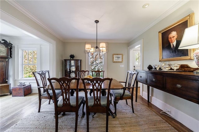202 Lakeview Ave, Atlanta, GA 30305 - dining room featuring a chandelier, crown molding, wood finished floors, and baseboards