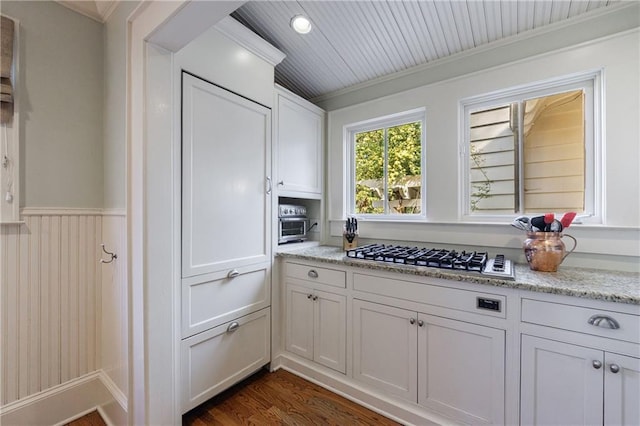 202 Lakeview Ave, Atlanta, GA 30305 - kitchen with white cabinets, dark wood finished floors, crown molding, stainless steel gas cooktop, and light stone counters