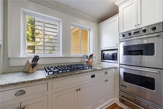 202 Lakeview Ave, Atlanta, GA 30305 - kitchen with a warming drawer, appliances with stainless steel finishes, white cabinetry, and light stone countertops