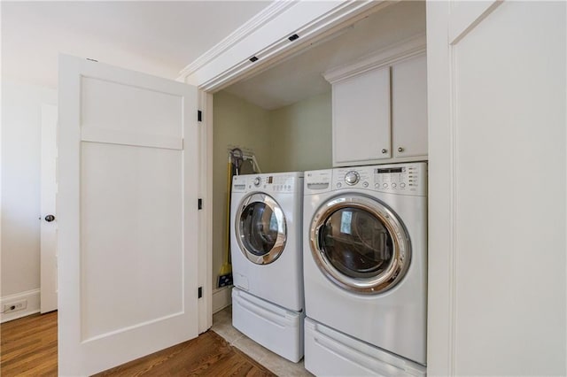 202 Lakeview Ave, Atlanta, GA 30305 - clothes washing area with cabinet space, washer and clothes dryer, and wood finished floors