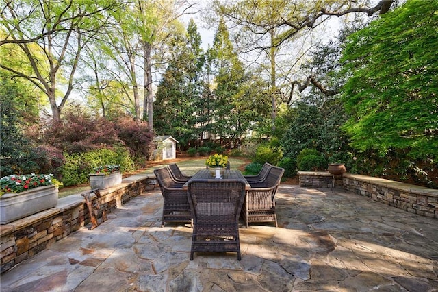 202 Lakeview Ave, Atlanta, GA 30305 - view of patio / terrace with an outbuilding, a storage unit, and outdoor dining space