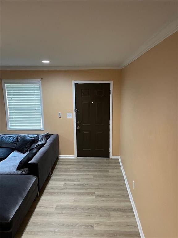 interior space featuring crown molding and light hardwood / wood-style flooring