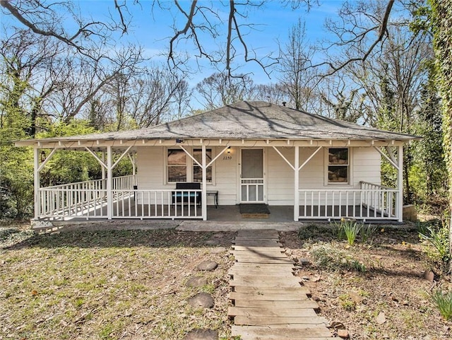 back of property with covered porch