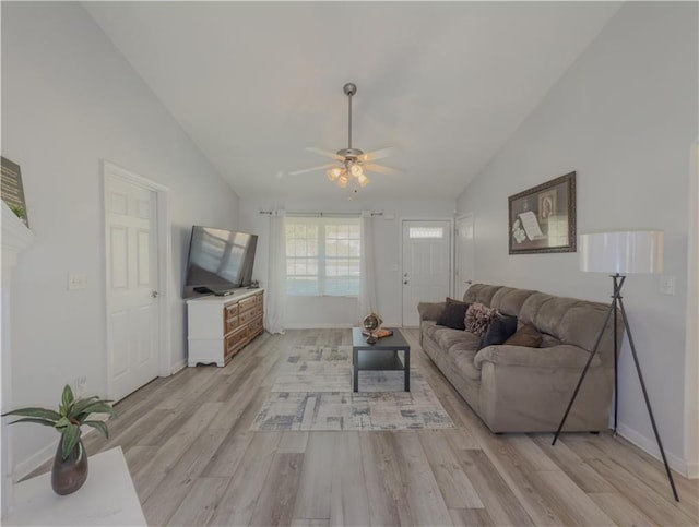 living room with light hardwood / wood-style floors, ceiling fan, and vaulted ceiling