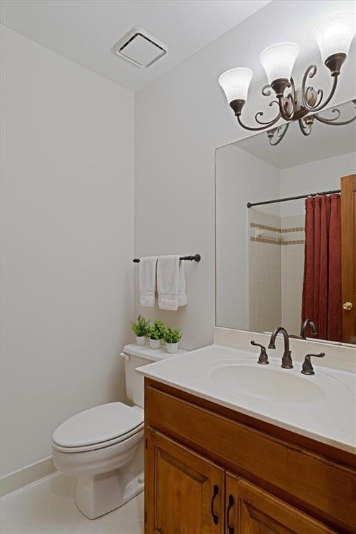 bathroom with curtained shower, a chandelier, tile patterned flooring, vanity, and toilet