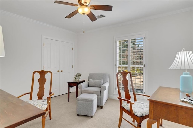 carpeted office space featuring ornamental molding and ceiling fan