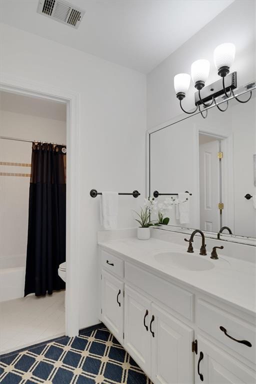 full bathroom featuring vanity, shower / bath combo, and toilet