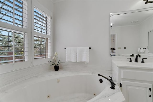 bathroom with vanity, crown molding, and a tub to relax in