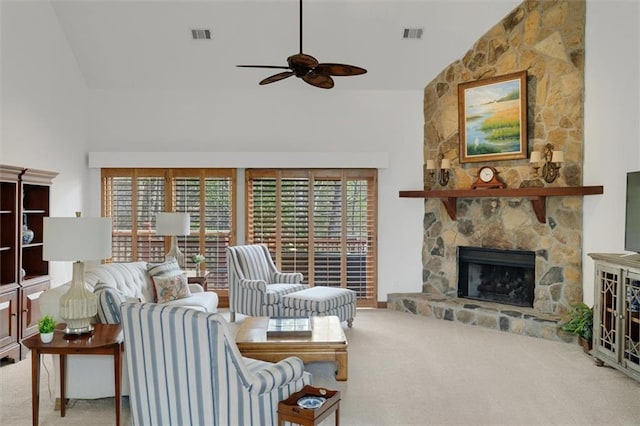 carpeted living room featuring ceiling fan, a fireplace, and high vaulted ceiling