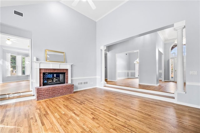 unfurnished living room with decorative columns and ceiling fan