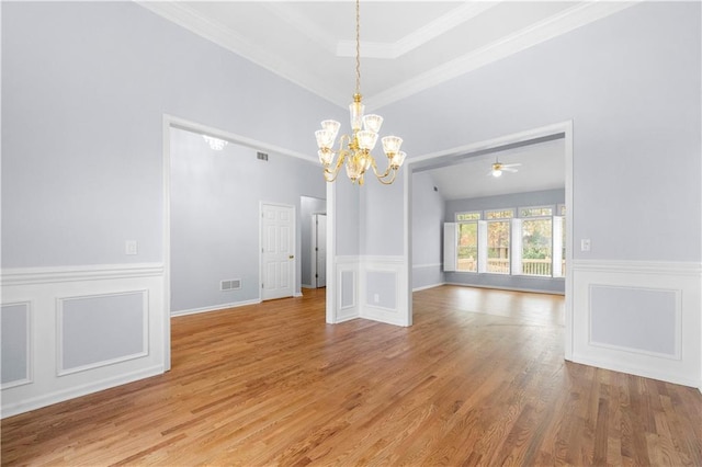 unfurnished dining area featuring crown molding, an inviting chandelier, and light hardwood / wood-style floors