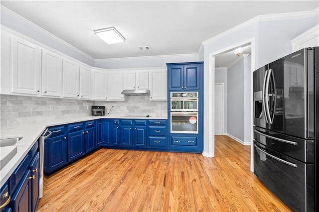 kitchen featuring white cabinetry, stainless steel appliances, light hardwood / wood-style floors, and blue cabinetry