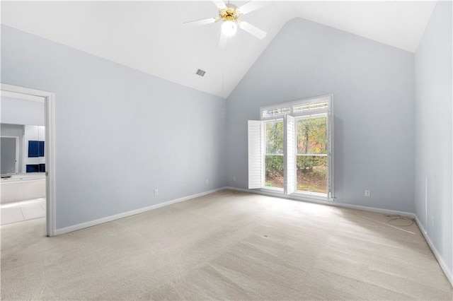 unfurnished room with ceiling fan, light carpet, and high vaulted ceiling