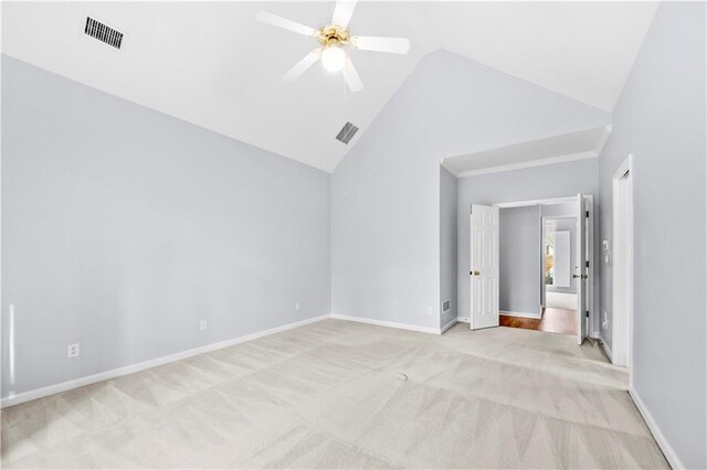 unfurnished bedroom with ceiling fan, ornamental molding, high vaulted ceiling, and light carpet