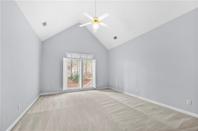 carpeted spare room with high vaulted ceiling and ceiling fan